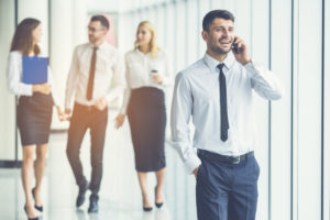 The businessman phone near partners on the sunny background